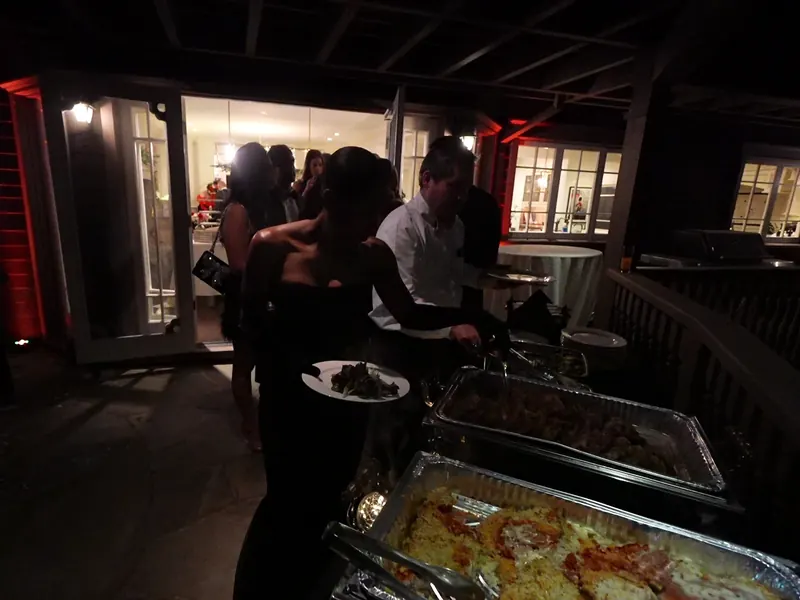 Hot buffet with chafing dishes as guests serve themselves in the evening
